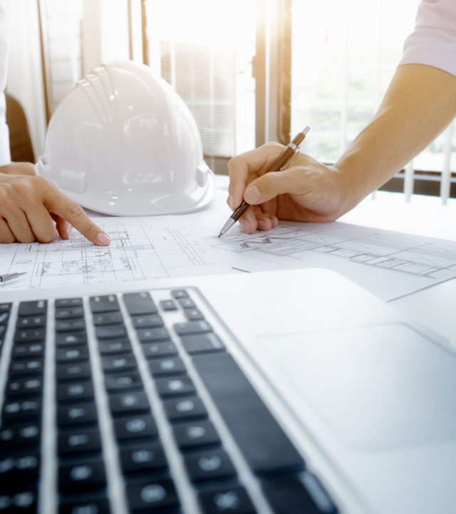 Image of engineer meeting for architectural project. working with partner and engineering tools on workplace vintage tone.